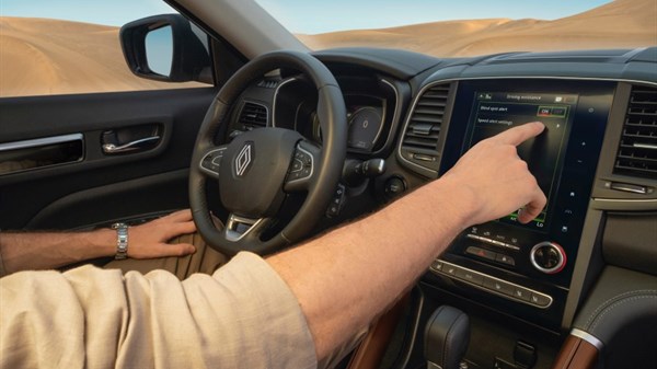 A man pressing vehicle button in the New Renault KOLEOS R-LINK 2 system